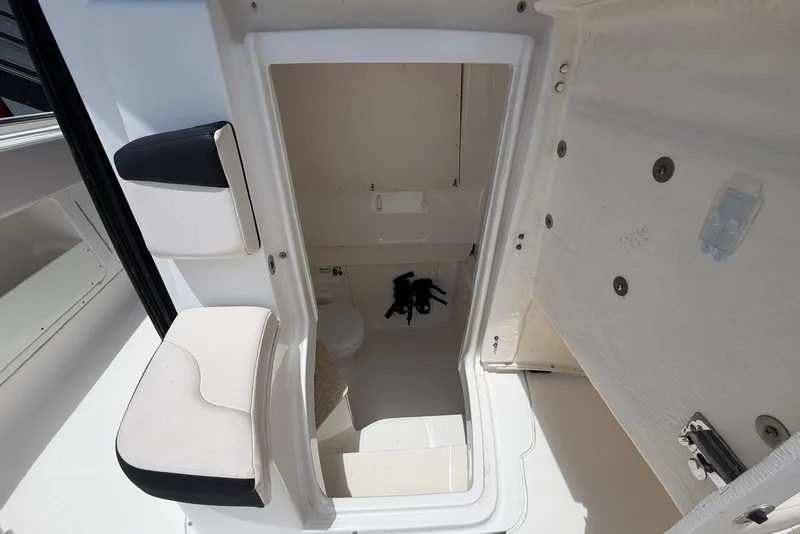 Slide: The Image of 2017 Robalo R302 Center Console boat interior with seating and storage area. - 23