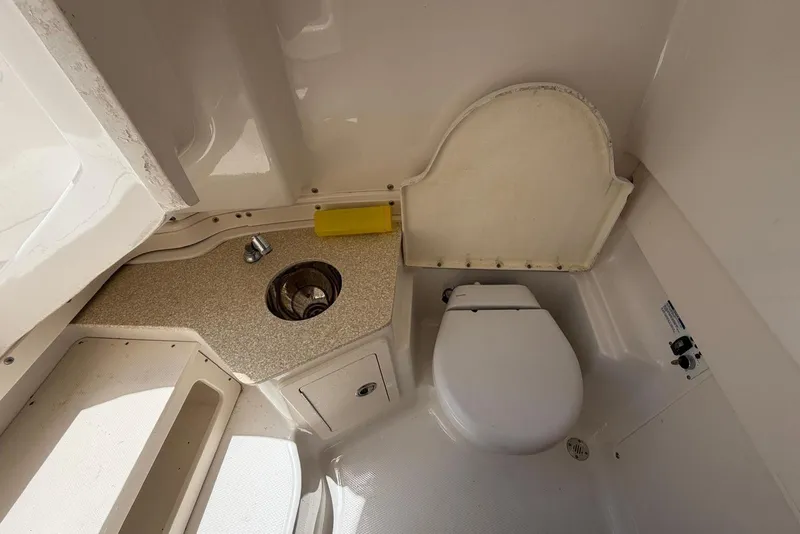 Slide: The Image of 2017 Robalo R302 Center Console boat interior with toilet and sink. - 24