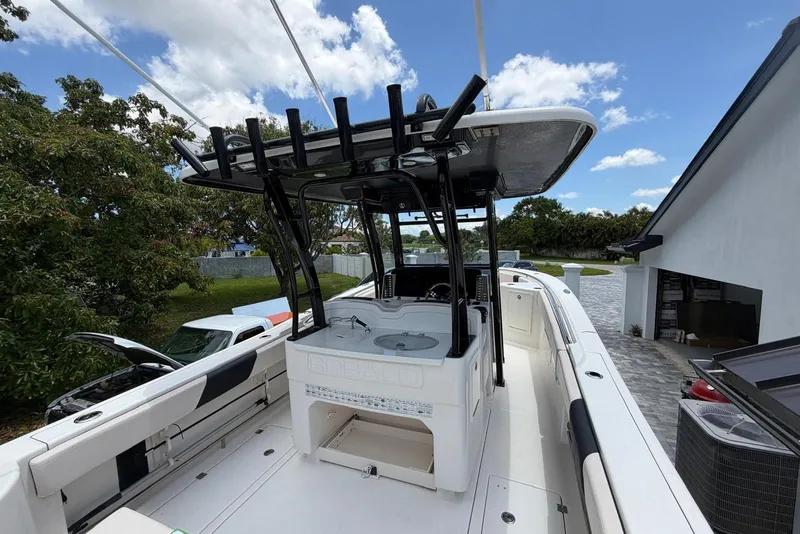 Slide: The Image of 2017 Robalo R302 Center Console boat with T-top, parked outdoors. - 27
