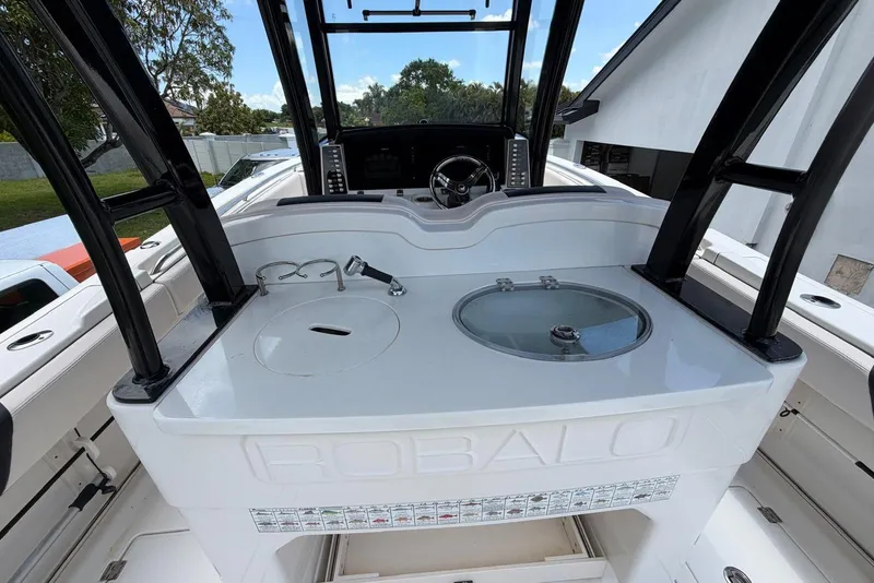 Slide: The Image of 2017 Robalo R302 Center Console boat interior with helm and fishing station. - 28