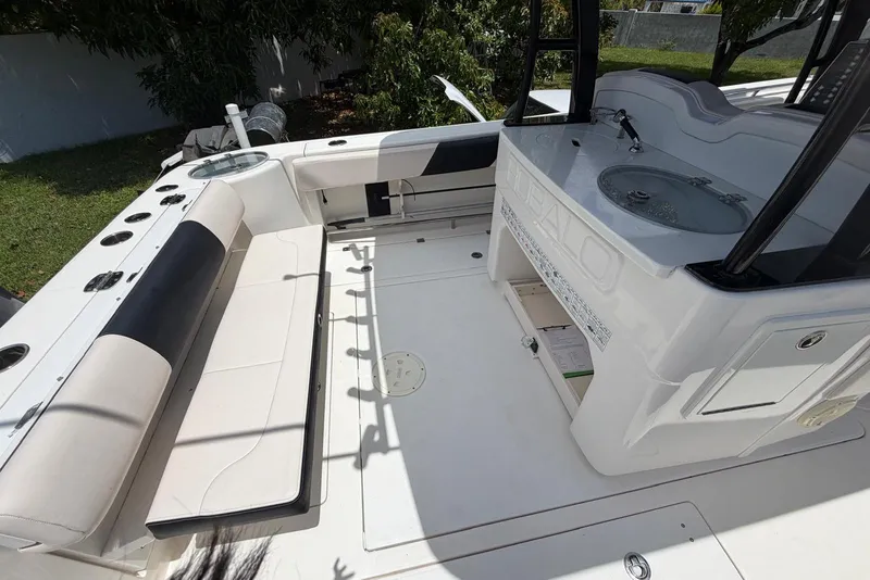 Slide: The Image of 2017 Robalo R302 Center Console boat interior with seating and fishing amenities. - 30
