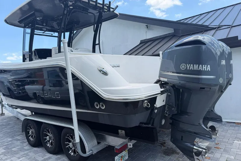 Slide: The Image of 2017 Robalo R302 Center Console boat with Yamaha engines on a trailer. - 31