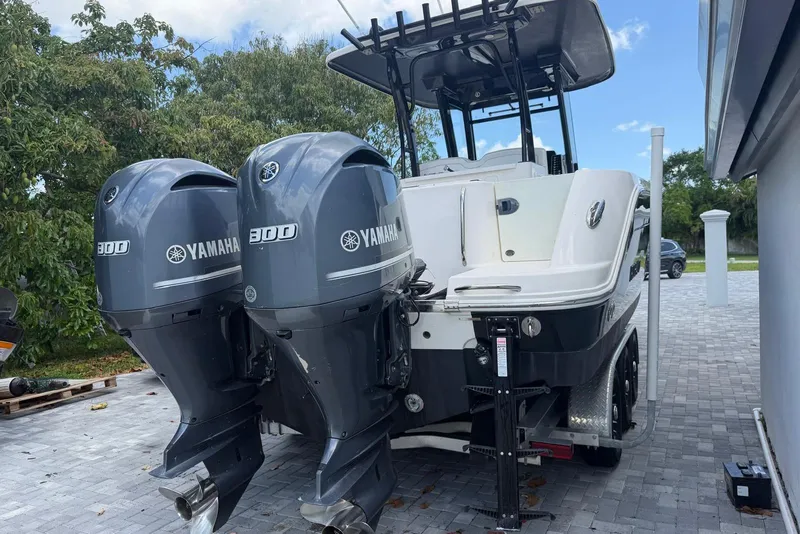 Slide: The Image of 2017 Robalo R302 Center Console boat with dual Yamaha 300 engines on a trailer. - 34