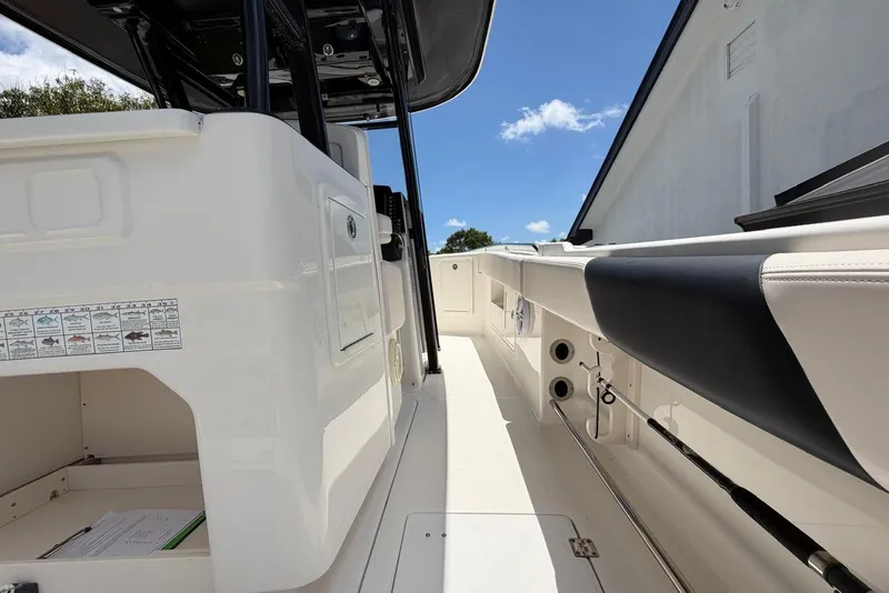 Slide: The Image of 2017 Robalo R302 Center Console boat interior with seating and storage compartments. - 7