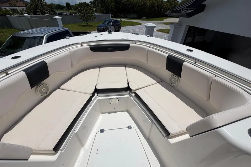 Slide: The Image of 2017 Robalo R302 Center Console boat with spacious seating area and sleek design. - 8