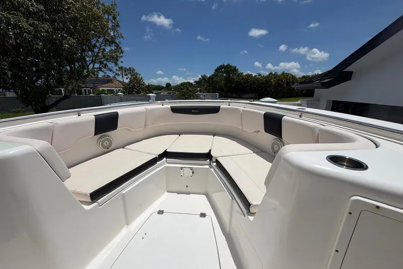 Slide: The Image of 2017 Robalo R302 Center Console boat with spacious seating under a clear blue sky. - 9
