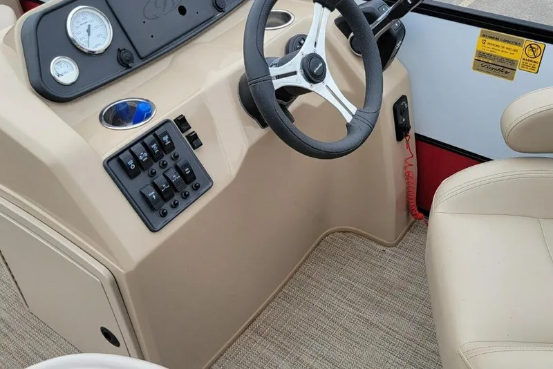 Slide: The Image of 2023 Bentley Pontoons 200 Fish dashboard with steering wheel and control panel. - 7