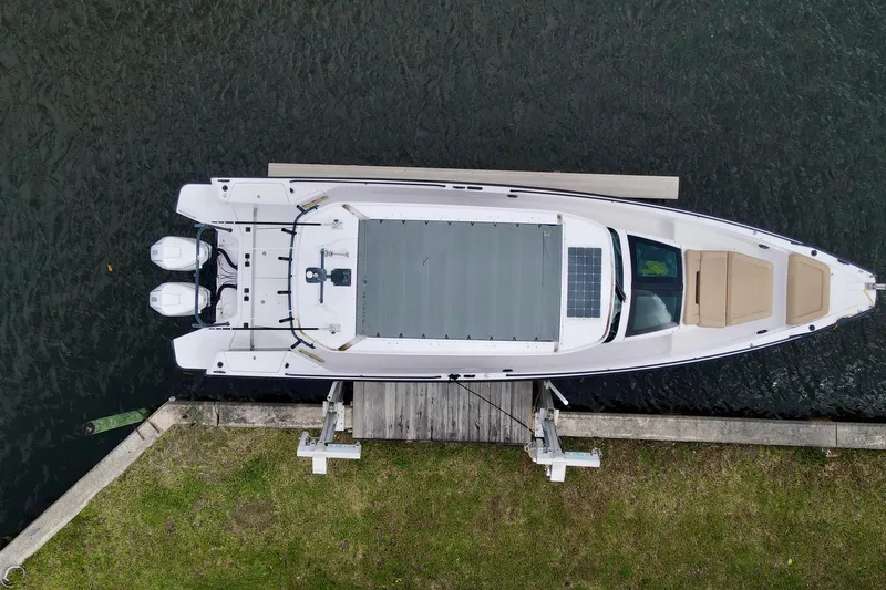 Slide: The Image of Overhead view of 2021 Axopar 37 Sun-Top boat docked by the water. - 2