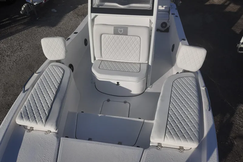 Slide: The Image of 2026 Sea Fox 231 Bay Fox boat interior with white quilted seating and spacious layout. - 9
