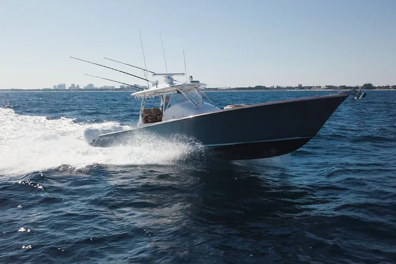 Slide: The Image of 2018 Winter Custom Yachts Center Console cruising on open water. - 3
