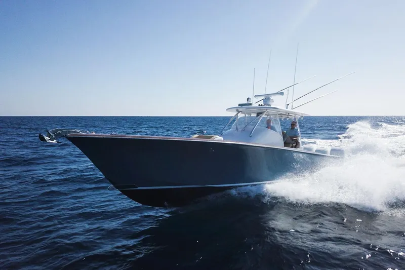 Slide: The Image of 2018 Winter Custom Yachts Center Console cruising on open ocean waters. - 4