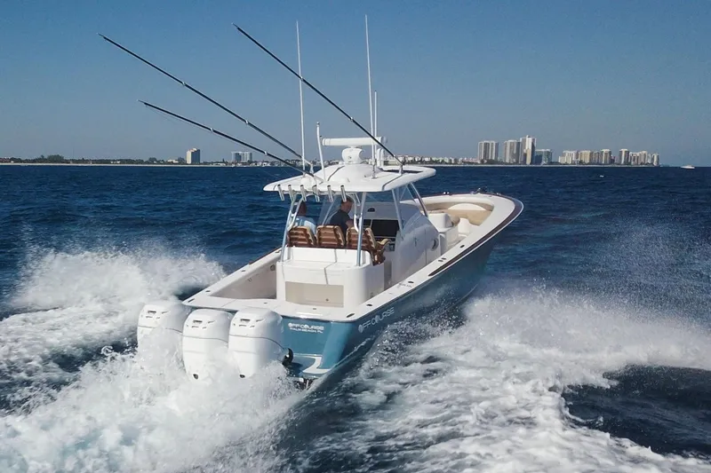 Slide: The Image of 2018 Winter Custom Yachts Center Console cruising on ocean with city skyline in background. - 5
