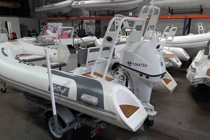 Slide: The Image of 2025 Tide Craft Catalina 13 boat with Tohatsu engine on trailer in showroom. - 3