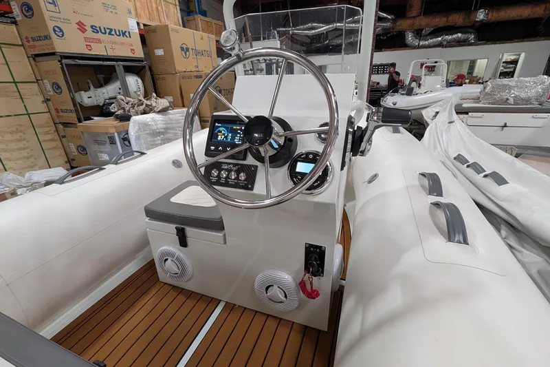 Slide: The Image of 2025 Tide Craft Catalina 13 boat interior with steering wheel and control panel. - 4