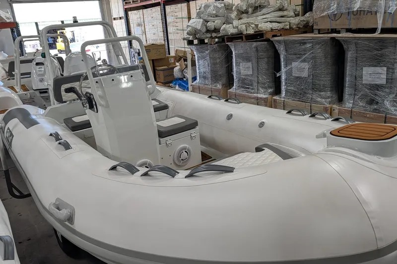 Slide: The Image of 2025 Tide Craft Catalina 13 boat with trailer in warehouse setting. - 5