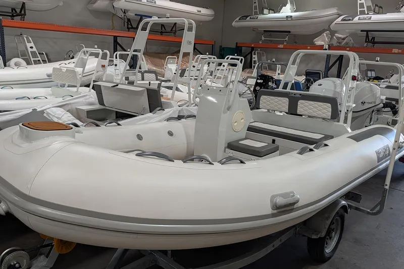 Slide: The Image of 2025 Tide Craft Catalina 13 inflatable boat with trailer in showroom. - 6