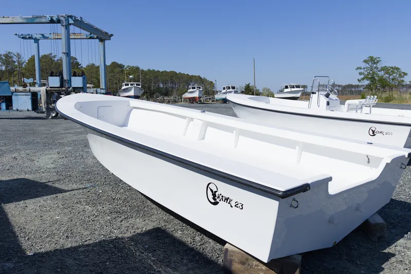 The Image of 2026 C-Hawk 23 Center Console boat in a marina setting. - 1