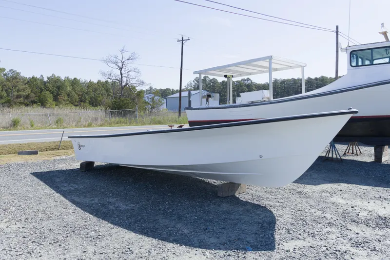 Slide: The Image of 2026 C-Hawk 23 Center Console boat displayed outdoors on gravel lot. - 5