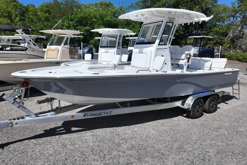 The Image of 2026 Sea Fox 251 Bay Fox boat on trailer, parked outdoors with trees in background. - 0