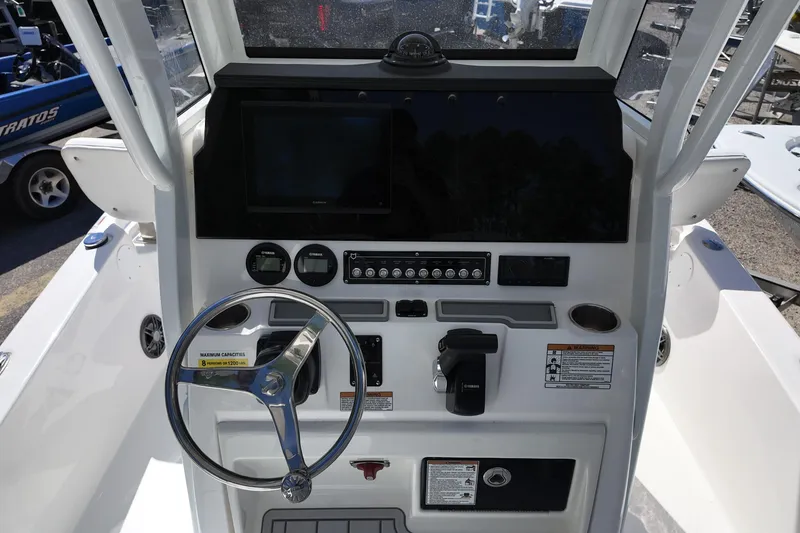 Slide: The Image of 2026 Sea Fox 251 Bay Fox boat console with steering wheel and navigation controls. - 5