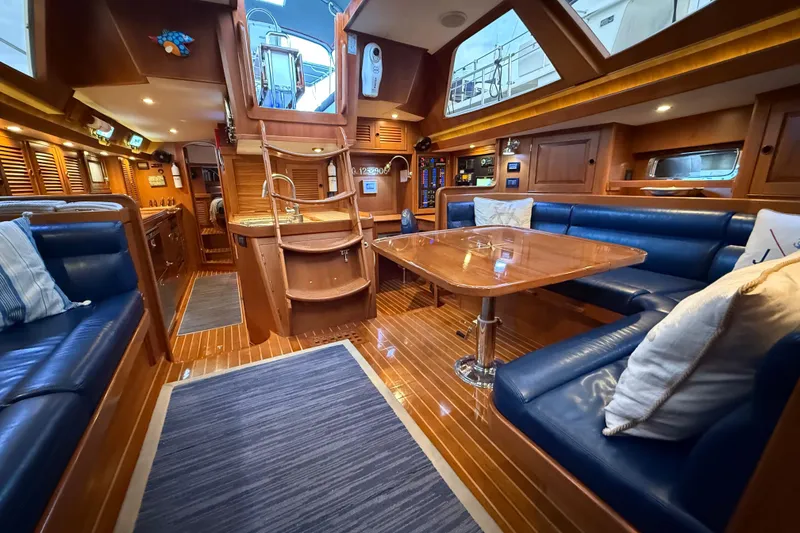 Slide: The Image of Luxurious interior of a 2014 Hylas 56 yacht with elegant wood finishes and blue seating. - 15