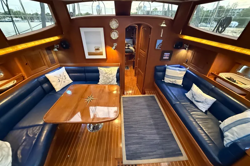 Slide: The Image of Luxurious 2014 Hylas 56 yacht interior with elegant wood finish and plush blue seating. - 18