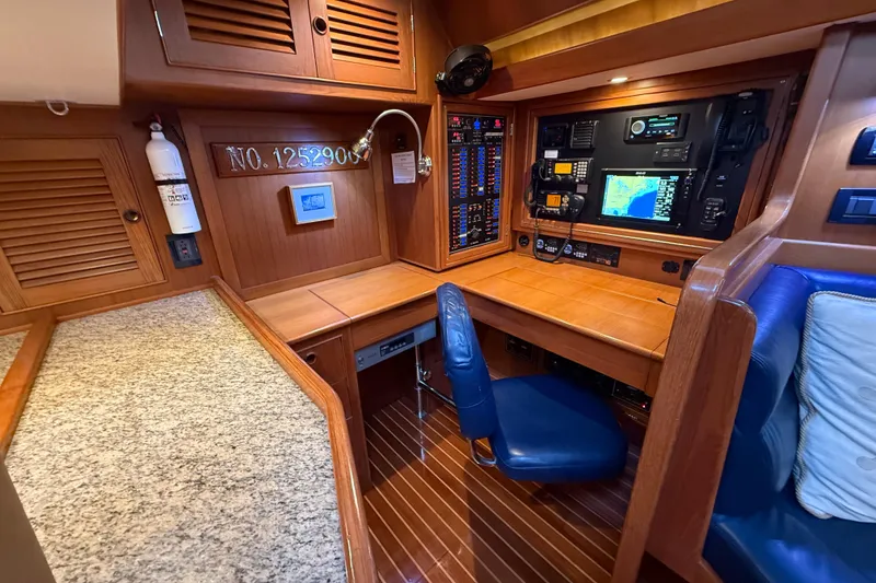 Slide: The Image of Luxurious 2014 Hylas 56 yacht interior with navigation station and wooden cabinetry. - 19