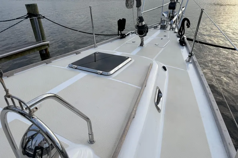 Slide: The Image of Deck view of a 2014 Hylas 56 yacht, featuring sleek design and ocean backdrop. - 2