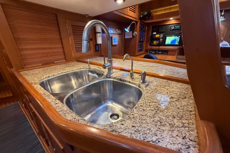 Slide: The Image of Luxurious 2014 Hylas 56 yacht interior with granite countertop and dual sink. - 22