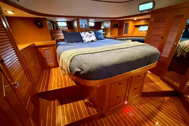 Slide: The Image of Luxurious 2014 Hylas 56 yacht cabin with wooden interior and cozy bedding. - 23