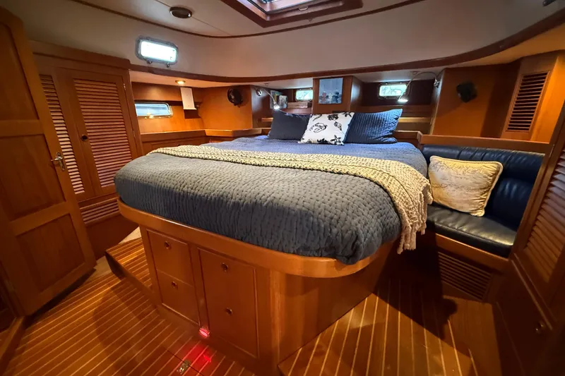 Slide: The Image of Luxurious cabin interior of a 2014 Hylas 56 yacht with cozy bedding and wooden finishes. - 24