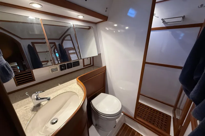 Slide: The Image of Luxurious bathroom in a 2014 Hylas 56 yacht, featuring modern fixtures and wooden accents. - 26