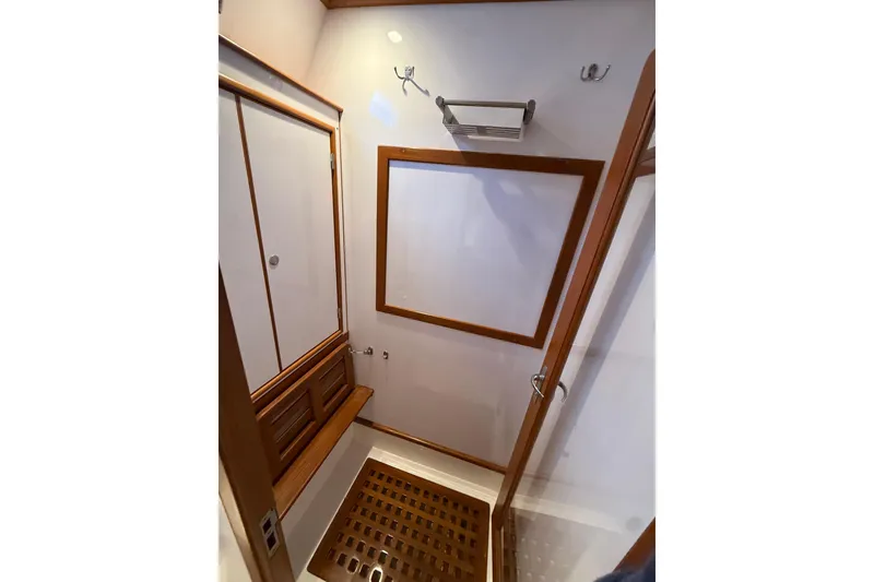 Slide: The Image of Interior of 2014 Hylas 56 yacht bathroom with wooden accents and shower area. - 27