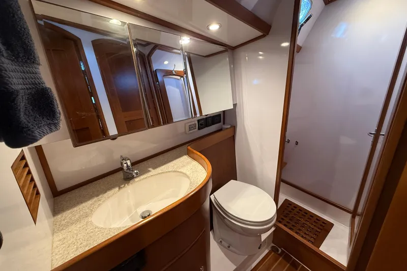 Slide: The Image of Luxurious bathroom interior of a 2014 Hylas 56 yacht, featuring modern fixtures and wood accents. - 29