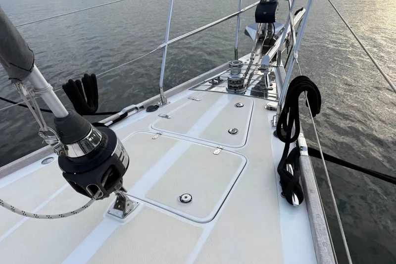 Slide: The Image of Deck of 2014 Hylas 56 yacht with winches and ropes, overlooking calm water. - 3