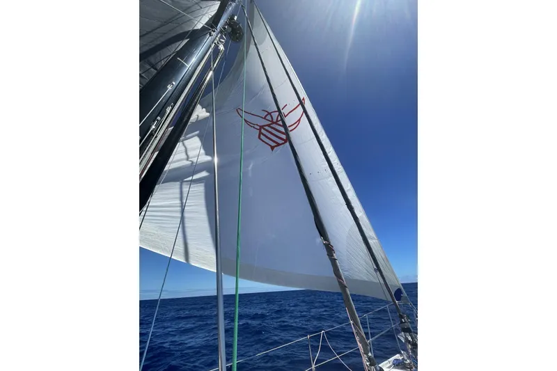 Slide: The Image of Sailing yacht Hylas 56, 2014 model, with sails unfurled on open ocean under clear blue sky. - 31