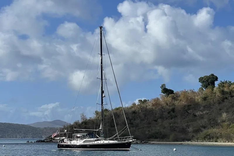 Slide: The Image of Sailboat Hylas 56 (2014) anchored near a scenic coastline under a blue sky. - 33