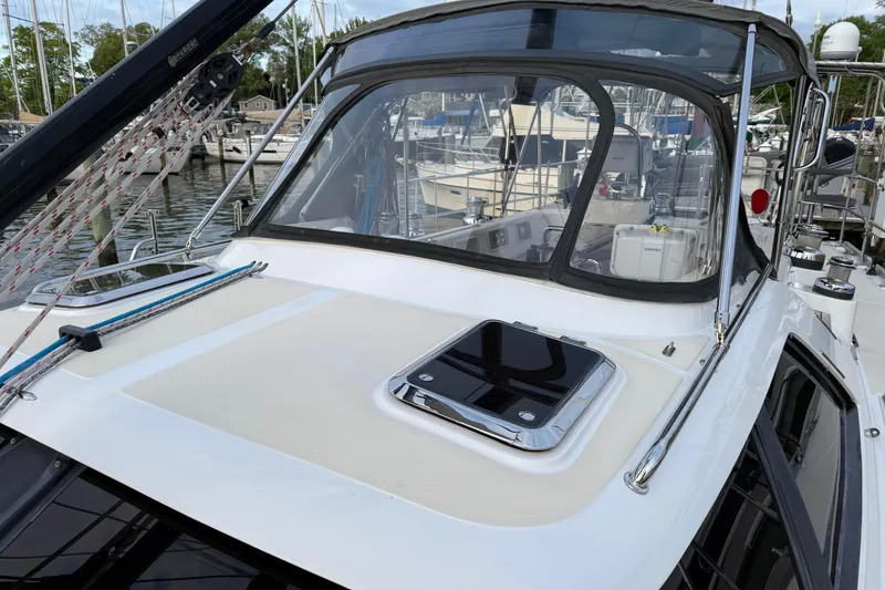 Slide: The Image of Sleek 2014 Hylas 56 yacht docked, showcasing deck and cockpit area. - 5