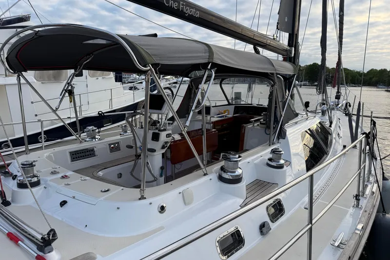 Slide: The Image of Luxury 2014 Hylas 56 yacht with sleek design, docked at marina under cloudy sky. - 7