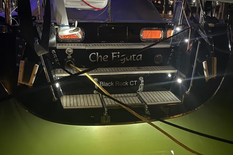 Slide: The Image of Stern view of 2014 Hylas 56 yacht named "Che Figata" docked at night. - 9