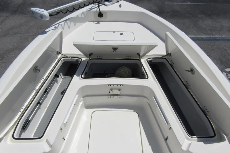 Slide: The Image of 2022 Skeeter SX2550 Fish boat storage compartments open, showcasing spacious interior design. - 13