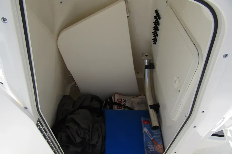 Slide: The Image of Storage compartment of 2022 Skeeter SX2550 Fish boat with various items inside. - 16