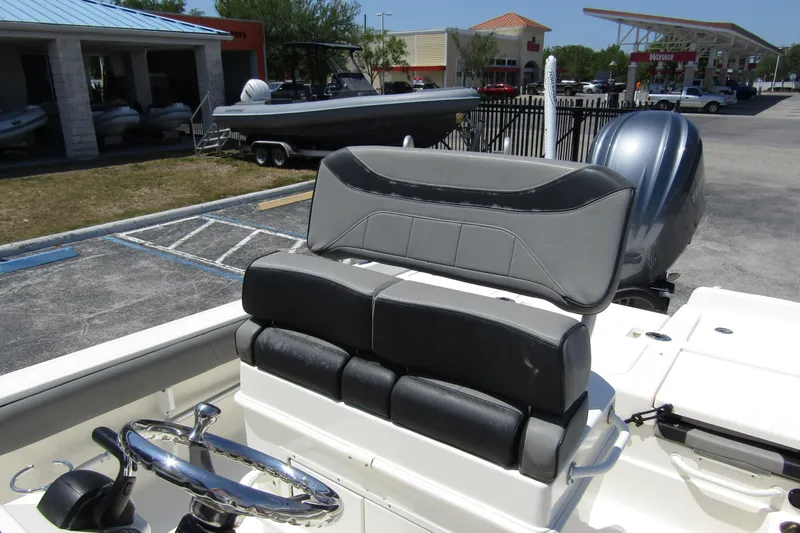 Slide: The Image of 2022 Skeeter SX2550 Fish boat with dual seating and steering wheel in a parking lot. - 17