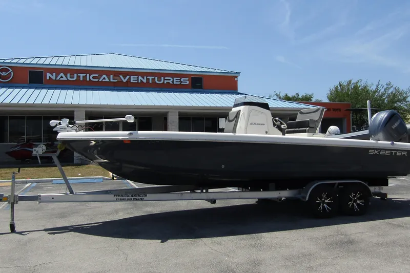Slide: The Image of 2022 Skeeter SX2550 Fish boat on trailer outside Nautical Ventures store. - 2