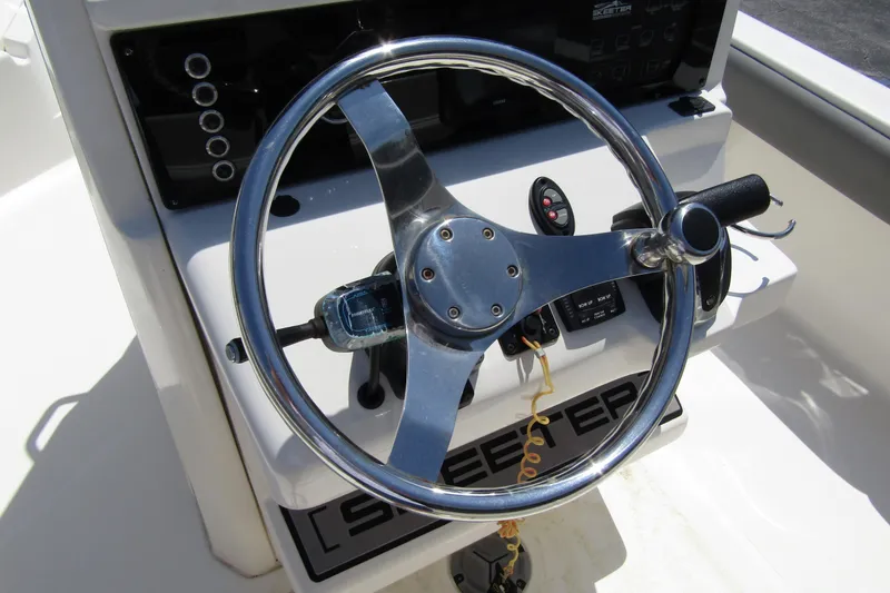 Slide: The Image of Steering wheel of 2022 Skeeter SX2550 Fish boat, featuring modern controls and dashboard. - 24