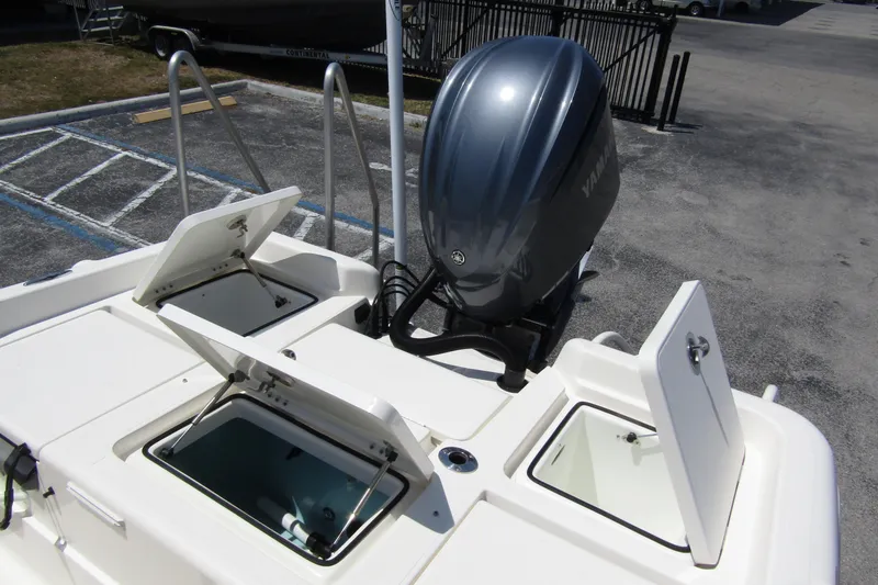 Slide: The Image of 2022 Skeeter SX2550 Fish boat with open storage compartments and Yamaha outboard motor. - 29