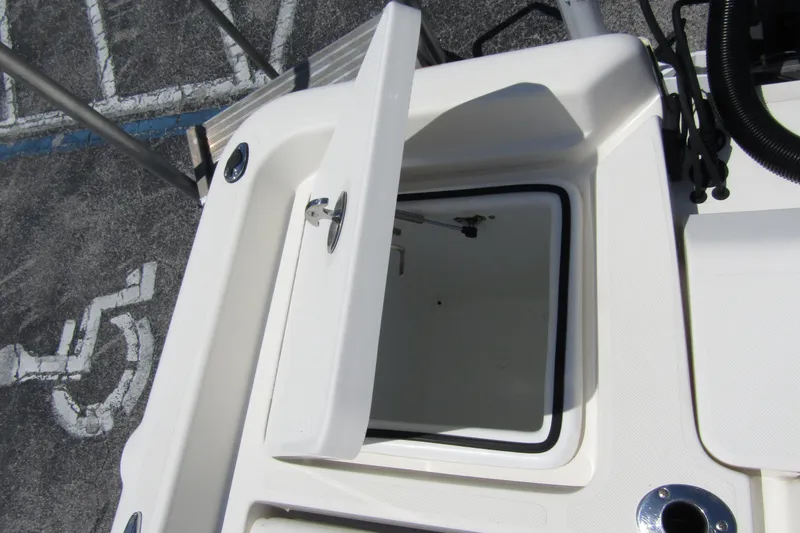 Slide: The Image of 2022 Skeeter SX2550 Fish boat storage compartment open, showcasing interior space. - 31