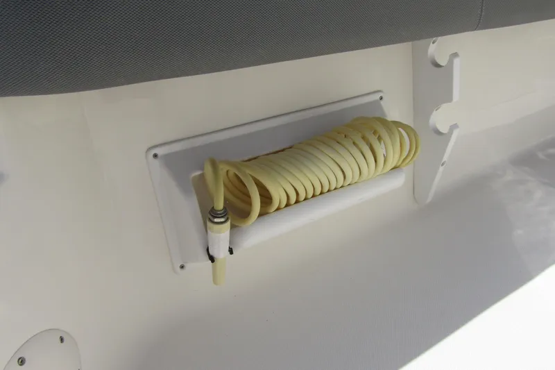 Slide: The Image of Coiled hose storage on 2022 Skeeter SX2550 Fish boat, featuring organized deck design. - 36