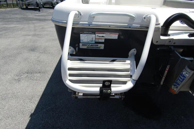Slide: The Image of 2022 Skeeter SX2550 Fish boat ladder on asphalt, showcasing rear entry design. - 6