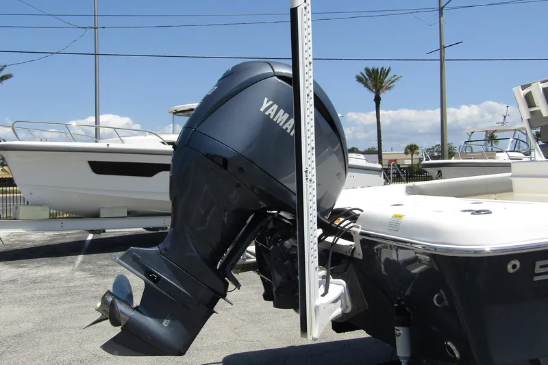 Slide: The Image of 2022 Skeeter SX2550 Fish boat with Yamaha outboard motor, parked outdoors. - 8
